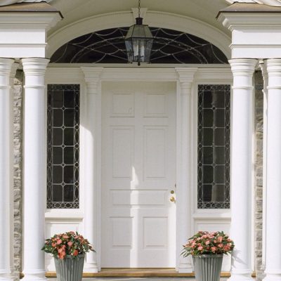 Wooden panel entry door with leaded glass overlay sidelites