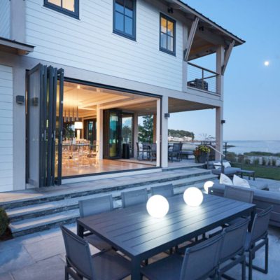 Steel Bi-Folding Doors Multi-panel steel bi-folding doors open dining area to view of the water