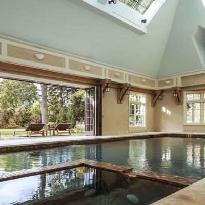 Multi-panel exterior bifold doors open indoor pool to the exterior
