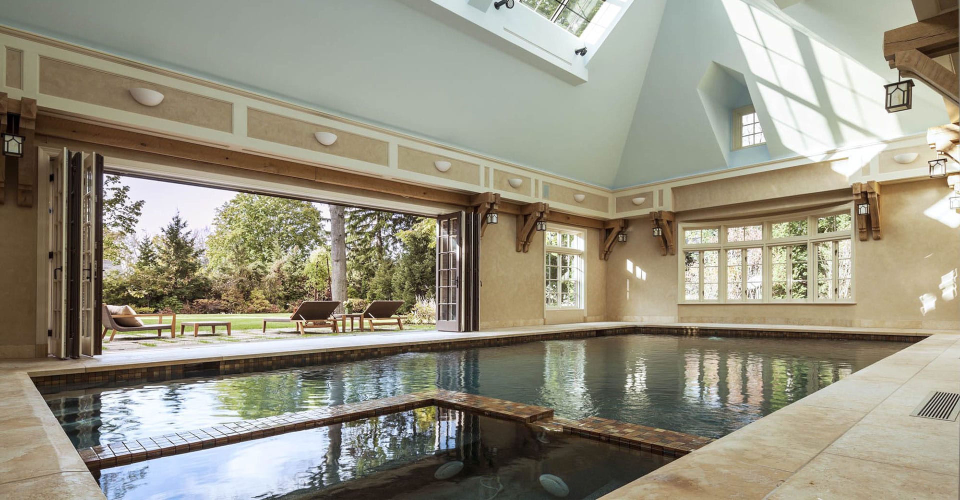 Multi-panel exterior bifold doors open indoor pool to the exterior