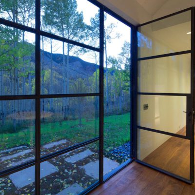 Glass door opening to the forest