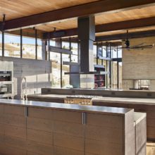 Modern kitchen with steel windows and mountain view in the background Modern kitchen with steel windows and mountain view in the background