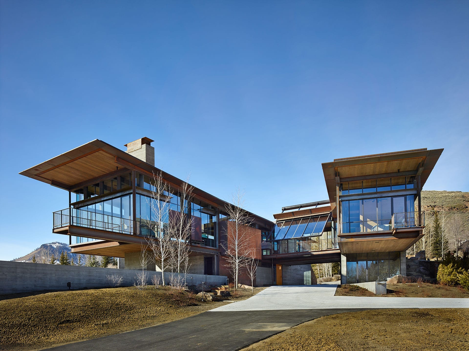 Bigwood residence with steel residential storefront windows and tilting window wall