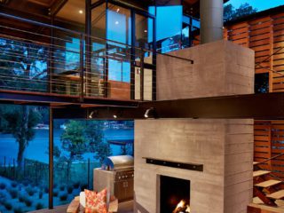 Two story fireplace and walkway overlooking the lake