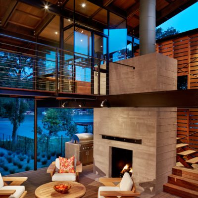 Two story fireplace and walkway overlooking the lake