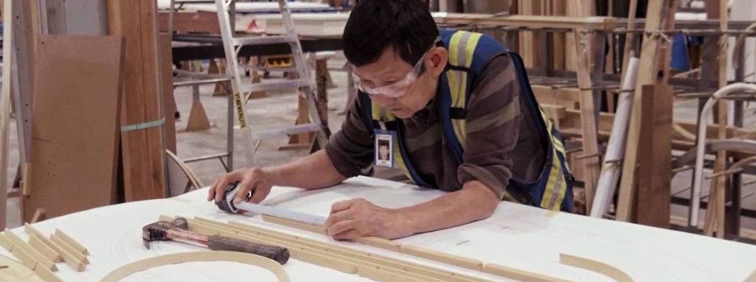 our-process-crop Window factory worker calculating lengths for custom wood windows