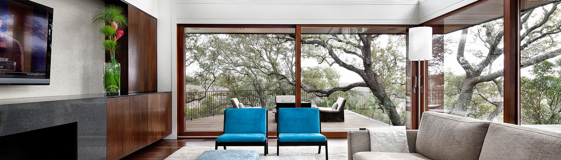 wood lift slide-1920x550 Wood lift and slide doors with view to trees outside