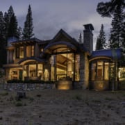 Exterior night view of modern mountain home with tall wood windows Exterior night view of modern mountain home with tall wood windows