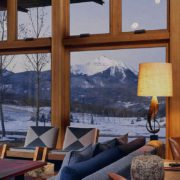 Looking through large custom wooden windows to reveal a beautiful mountain landscape.