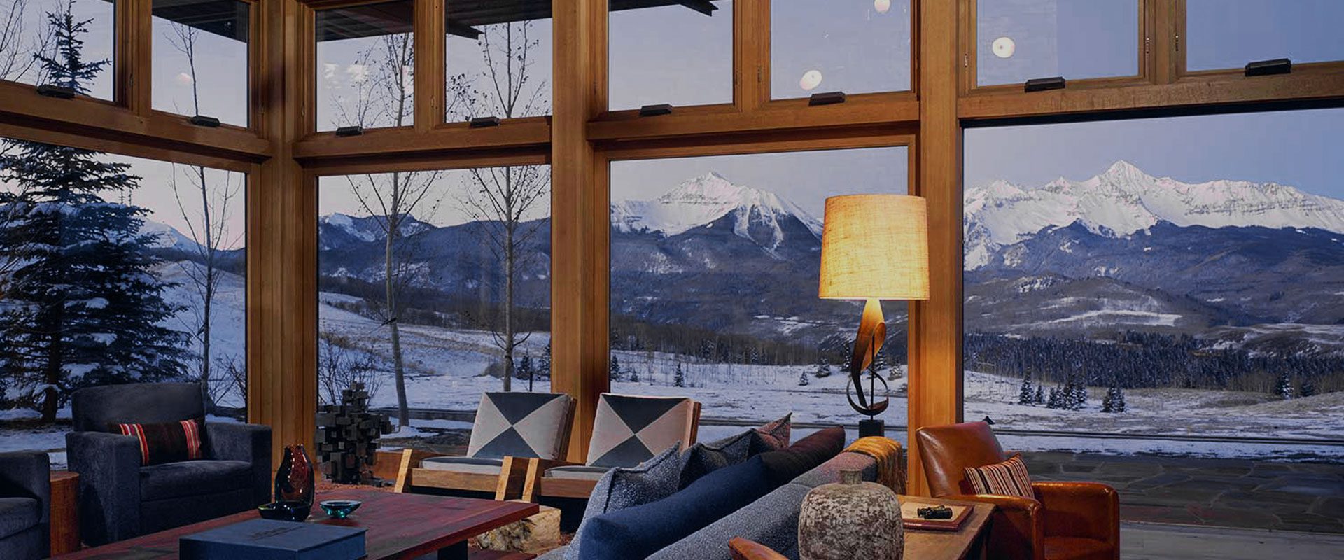 Looking through large custom wooden windows to reveal a beautiful mountain landscape.