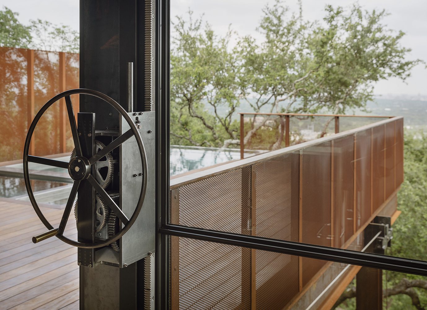 hand operated wheel with exposed counterweights to lower massive window wall