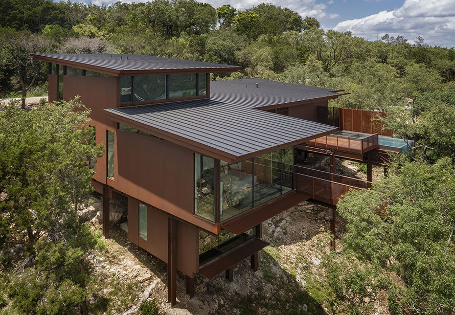 Modern mountain home with residential window wall perched on a cliff