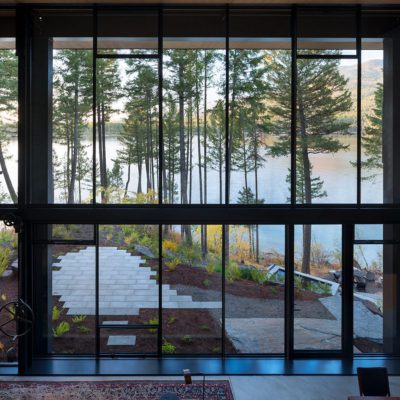 Guillotine window by Olson Kundig overlooking a lake Guillotine window by Olson Kundig overlooking a lake