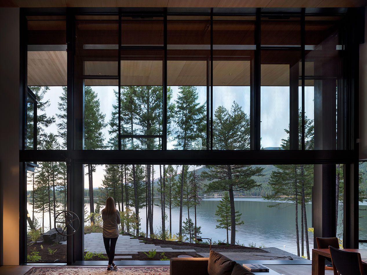 Olson Kundig designed open guillotine window overlooking a lake