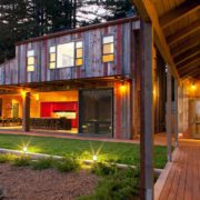 Modern rustic farmhouse at night