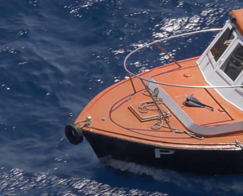 Harbor pilot ship floats in the water waiting to guide a ship into shore